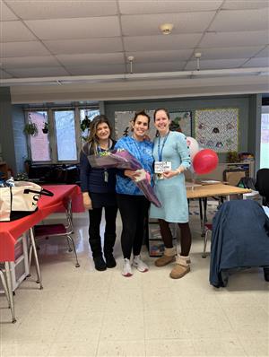 3 teachers in classroom with flowers